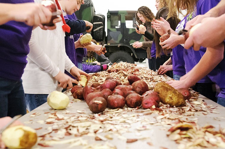 &lt;p&gt;Students from Trinity Lutheran School peel potatoes Friday morning in preparation for Christmas at Our House at the National Guard Armory north of Kalispell. The free annual event runs from 11 a.m. to 6 p.m. Saturday at the&#160;Armed Forces Reserve Center off U.S. 93 north of Kalispell. No reservation is needed. Call 871-7604 for more information.&lt;/p&gt;