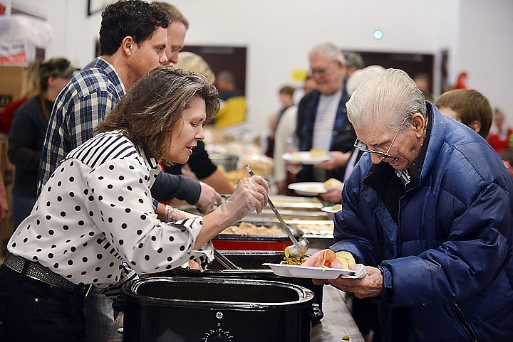 &lt;p&gt;Bob Miller of Columbia Falls, right, goes through the lunch line on Saturday, December 14, at the 24th Annual Christmas at Our House. On the left is volunteer Tina Malkuch of Kalipsell. (Brenda Ahearn/Daily Inter Lake)&lt;/p&gt;