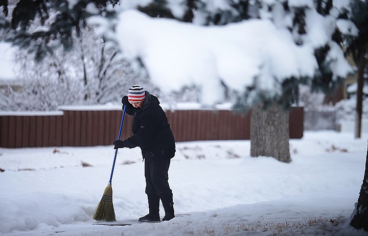 &lt;p&gt;Pat Conner sweeps the sidewalk clear of snow on Wednesday, December 11, in Kalispell. This portion of the sidewalk is in front of her neighbor's home. Conner said he normally takes care of the sidewalks for her, today, she wanted to beat him to them and to take care of his as well as hers. (Brenda Ahearn/Daily Inter Lake)&lt;/p&gt;