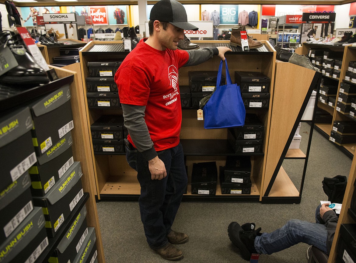 &lt;p&gt;Boys and Girls Club volunteer Matt Church helps his 13-year-old Christmas kid, Alex Mcglothen, choose a pair of winter boots Thursday evening at Kohl&#146;s.&lt;/p&gt;