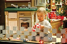 Peter Dupuis, 6, plays in the window of the Gift Gallery and Anura shops on Polson's Main Street Friday night during the Living History windows display event.