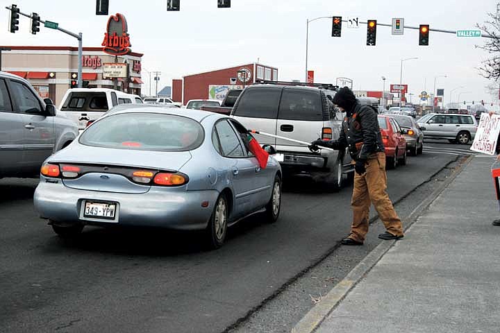 Members of the Unchained Brotherhood hit the street at the traffic light, collecting donations for Christmas toys along Stratford Avenue in Moses Lake Saturday.