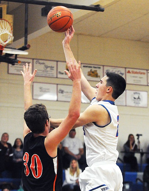 <p>Bigfork's George Gibson shoots over Eureka's Sam Hannay during the third quarter in Bigfork on Thursday. (Aaric Bryan/Daily Inter Lake)</p>