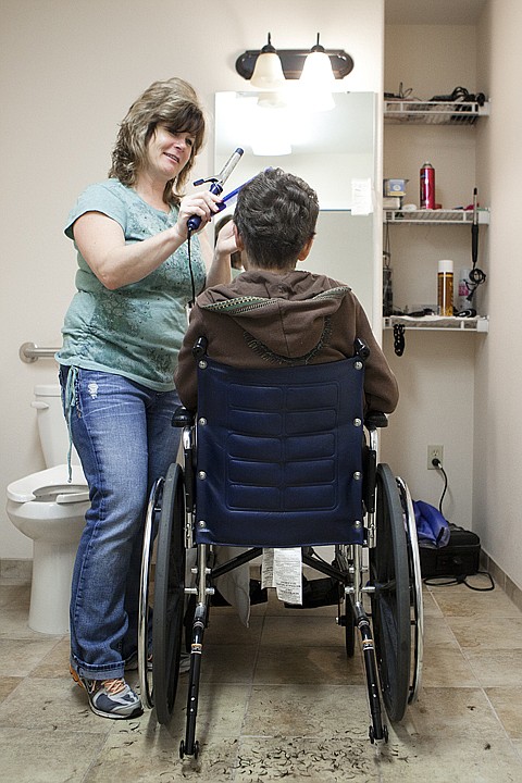<p>Pam Burns curls Judy Gradys hair at Expressions Inc. Thursday
afternoon. Burns, a stylist at Sheer Perfection in Columbia Falls,
comes to Expressions every Thursday to work on the hair of
residents who want it.</p>