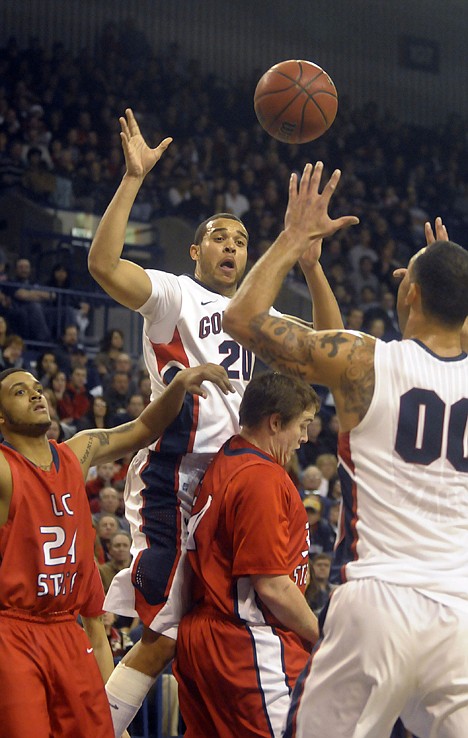 &lt;p&gt;Gonzaga's Elias Harris (20) passes to Robert Sacre (00) while defended by Lewis-Clark State's Devon Adams (24) and Ray Stout in the first half Thursday night at Spokane.&lt;/p&gt;