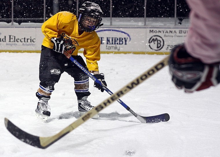 Maria Makman practices passing the puck back and forth with U-19 girls player Liz Poole.