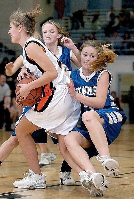 Columbia Falls Wildkats Alyssa Ladenburg and Callie Spencer battle for the ball with Flathead's Annie Braseth during second half action Friday in Kalispell. Flathead defeated the Wildkats, 56-37. Karen Nichols/Daily Inter Lake