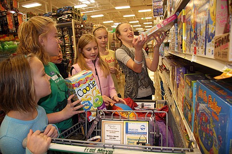 &lt;p&gt;The Spellman and Schaffer cousins of Coeur d'Alene decided to forego their Christmas presents to each other this year and start a new tradition by contributing to Toys for Tots instead. From left, Emily Spellman, 9, Kaitlyn Spellman, 11, Alyssa Schaffer, 12, Brooklin Shaffer, 12 and Kelsie Spellman, 10, shop at Fred Meyer on Saturday for the nonprofit's campaign.&lt;/p&gt;