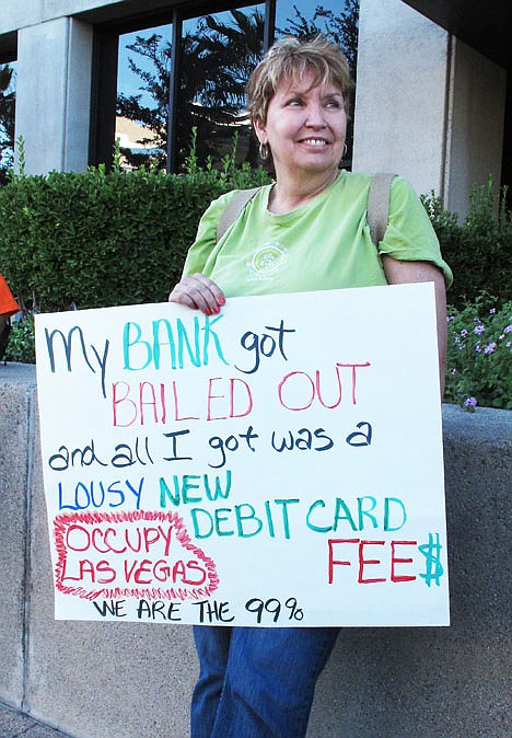<p>Retired state worker Donna West, 55, gathers with Wall Street protesters outside a Bank of America building in Las Vegas to protest record bank profits on Oct. 28.</p>