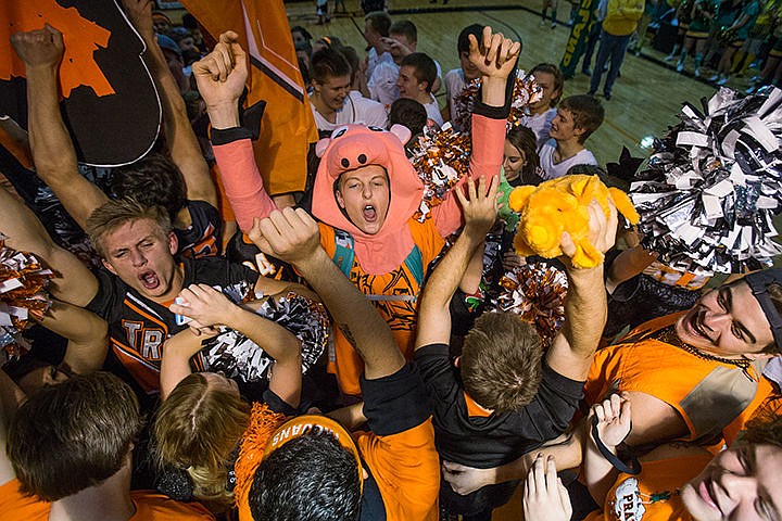 &lt;p&gt;Post Falls&#146; Drew Johnston, center, celebrates the Trojans&#146; win in the annual Prairie Pig competition held during the Trojans&#146; game against the Lakeland Hawks in Post Falls on Friday, Dec. 19, 2014. The Trojans won this years Prairie Pig spirit competition.&#160;&lt;/p&gt;