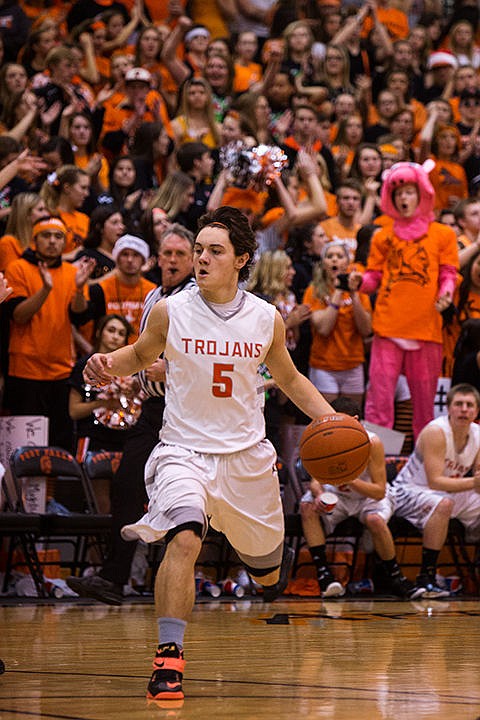 &lt;p&gt;Students from Post Falls High School cheer on Post Falls&#146; guard Max McCullough as he dribbles towards the Trojans&#146; offensive end in the final period of the game. Post Falls won the annual Prairie Pig compeition against the Lakeland Hawks in Post Falls on Friday, Dec. 19, 2014.&lt;/p&gt;