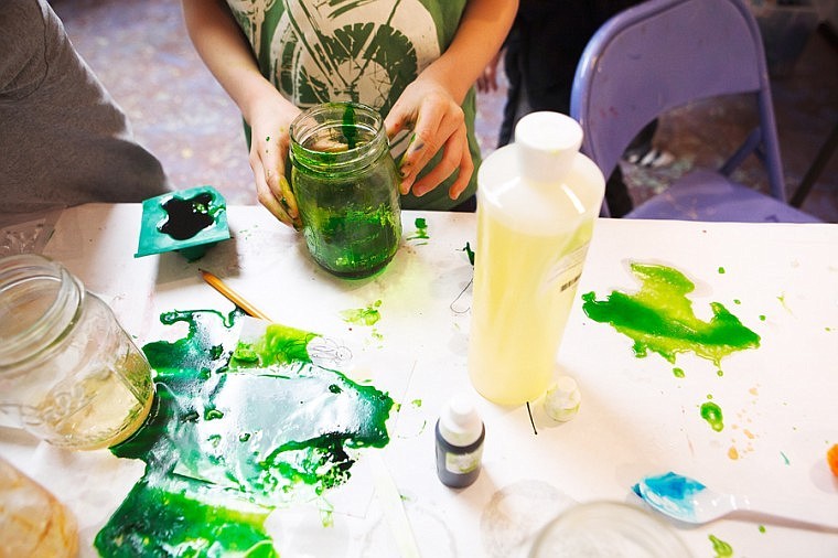 <p>A student mixes in coloring to his melted glycerine Tuesday evening at Stumptown Art Studio in Whitefish. </p>