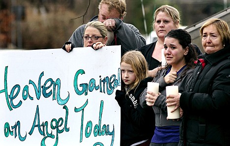 &lt;p&gt;Tom Doyle, back left, standing with family and co-workers, wipes his face as the funeral procession for 6-year-old James Mattioli, who died in the Sandy Hook Elementary School shootings, approaches the St. John's Cemetery Tuesday in Darien, Conn. Center are his wife Debbie and daughter Emily, 10. Adam Lanza opened fire at the Sandy Hook Elementary School in Newtown on Friday, killing 26 people, including 20 children.&lt;/p&gt;