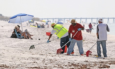 &lt;p&gt;Oil cleanup workers clean up tar balls on Pensacola Beach, Fla., on Aug. 1. The lingering economic recession, a record cold Florida winter and the effects of the Gulf oil spill stalled the tourist traffic this year in parts of Florida.&lt;/p&gt;