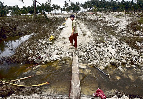 &lt;p&gt;A tsunami survivor walks across his village which was hit by an earthquake-triggered tsunami Oct. 30 at Munta, North Pagai Island, West Sumatra, Indonesia.&lt;/p&gt;