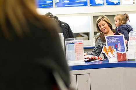 &lt;p&gt;Summer Durand, with her 1-year-old daughter Taylor Stack, gathers her packages in preparation to mail them Tuesday at the United States Post Office in Coeur d'Alene.&lt;/p&gt;