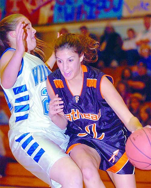 Chris Jordan/Daily Inter Lake&lt;br&gt;Flathead's Lindsay Bennett drives past Columbia Falls' Beth Karper during the first half of Flathead's 61-49 win over Columbia Falls on Friday night in Columbia Falls.