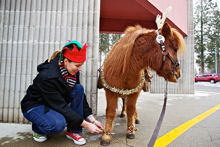 &lt;p&gt;JEROME A. POLLOS/Press Kathy Baker, principal of Ponderosa Elementary School, secures bells to the feet of a &quot;reindeer in training&quot; before taking it on a tour of the Post Falls' school Friday.&lt;/p&gt;