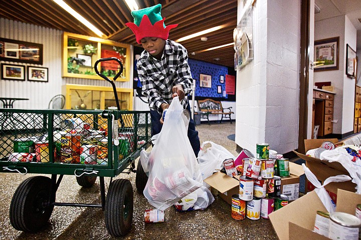 &lt;p&gt;JEROME A. POLLOS/Press Jeremiah Moss, 9, sorts through and bags the food items he collected Friday from the classrooms at Ponderosa Elementary in Post Falls. Moss recently helped collect over 500 books for a classroom book drive.&Ecirc;When he heard the Post Falls Food Bank was in need of donations, he spearheaded a food drive collecting roughly 600 pounds from his classmates and staff at the school.&lt;/p&gt;