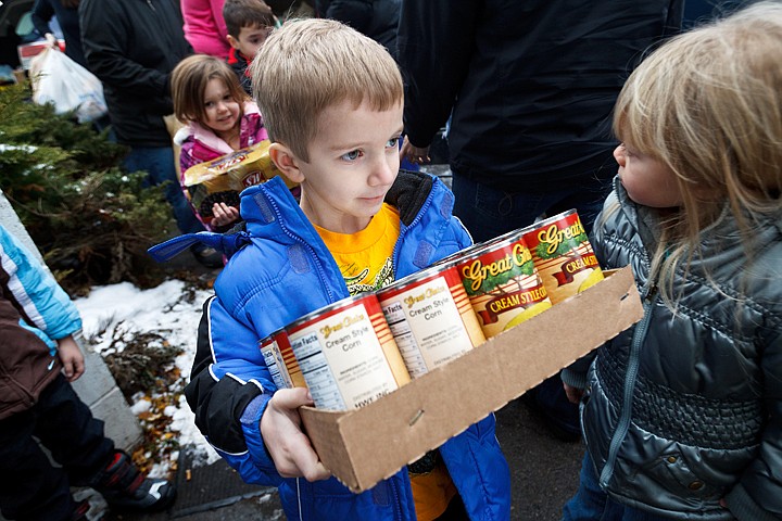 &lt;p&gt;SHAWN GUST/Press Kyle Waddell, 4, a student at Noah's Ark Learning Center, carries a box of canned goods Friday as children and parents delivered 2,116 pounds of food to Community Action Partnership in Coeur d'Alene. The school has been collecting the food over a two week period.&lt;/p&gt;