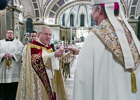 &lt;p&gt;The Rev. Gerald Funke, Diocesan Administrator for the Roman Catholic Diocese of Boise, hands the ceremonial keys of St. John's Cathedral to the Rev. Peter F. Christensen, bishop designate, at the entrance of the cathedral Tuesday.&lt;/p&gt;