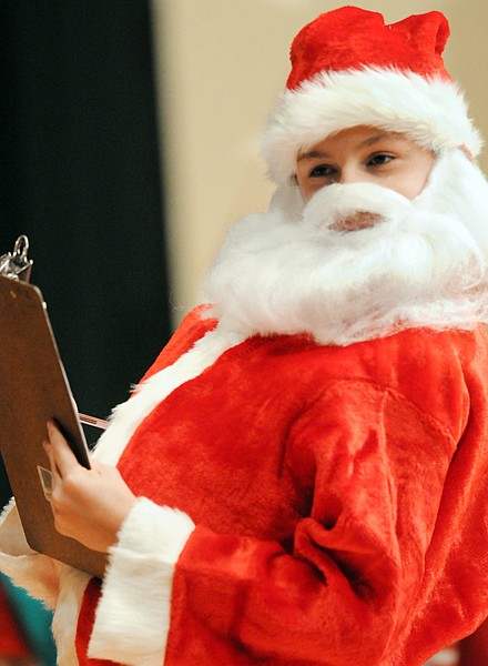 Mathew Martini checks his list twice as Santa in The Penguins Who Saved Christmas by the Kalispell Montessori Elementary on Tuesday at Glacier High School.