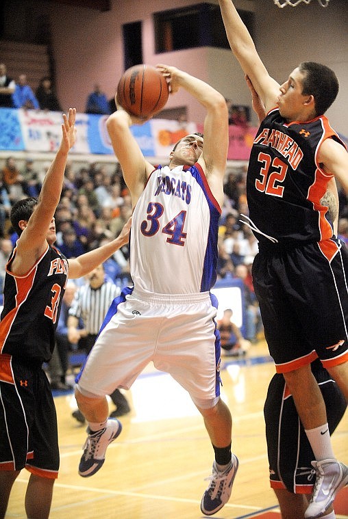 Brenda Ahearn/Daily Inter Lake
Columbia Falls senior Mitchell Wassam (34) shoots under pressure from Flathead junior Mike VanArendonk (left) and sophomore George Sherwood (32) during Thursday&#146;s nonconference game in Columbia Falls.