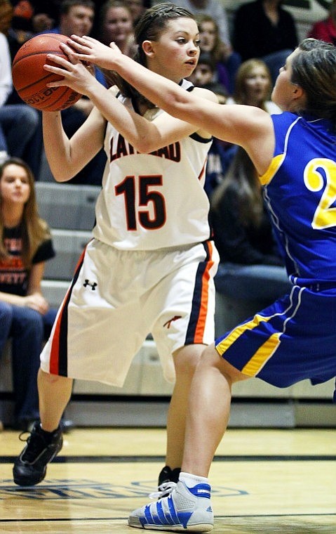 Flathead's Taylor Twichel (15) looks for an open teammate while by Libby's Alysha Martin defends during Saturday evening's game.