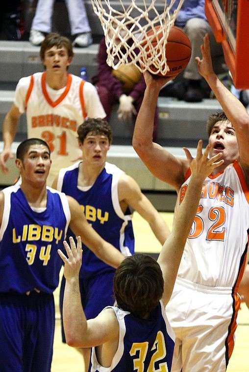 Flathead's Jeremy Grosswiler goes up for a shot while Libby's Garrett Craig (32) tries to block him in the second quarter of Saturday evening's game.