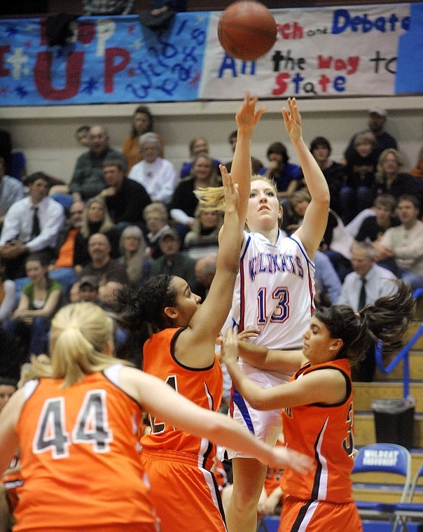 Columbia Falls junior Kayla DeWit (13) shooting under pressure from Flathead defenders during their game on Thursday.