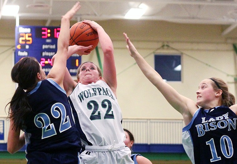 Glacier's Baylee Quay goes up for a shot over Great Falls' Sarah Scermele while Allison Owen reaches out in attempt to block the shot during the second half of Friday afternoon's game at Glacier.