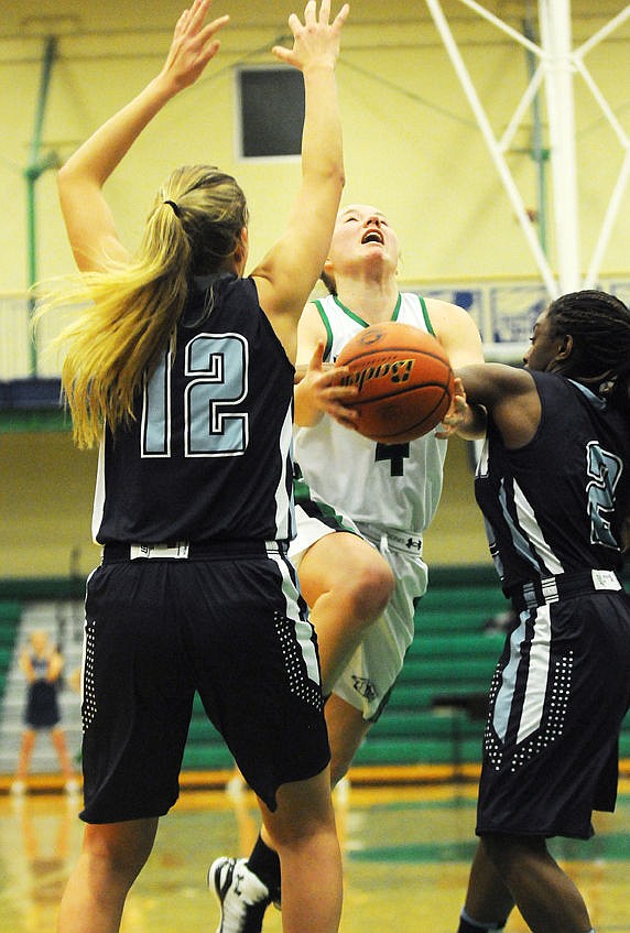 <p>Hailee Bennett is fouled by Great Falls Hannah Collins as she drives to the hoop. (Aaric Bryan/Daily Inter Lake)</p>
