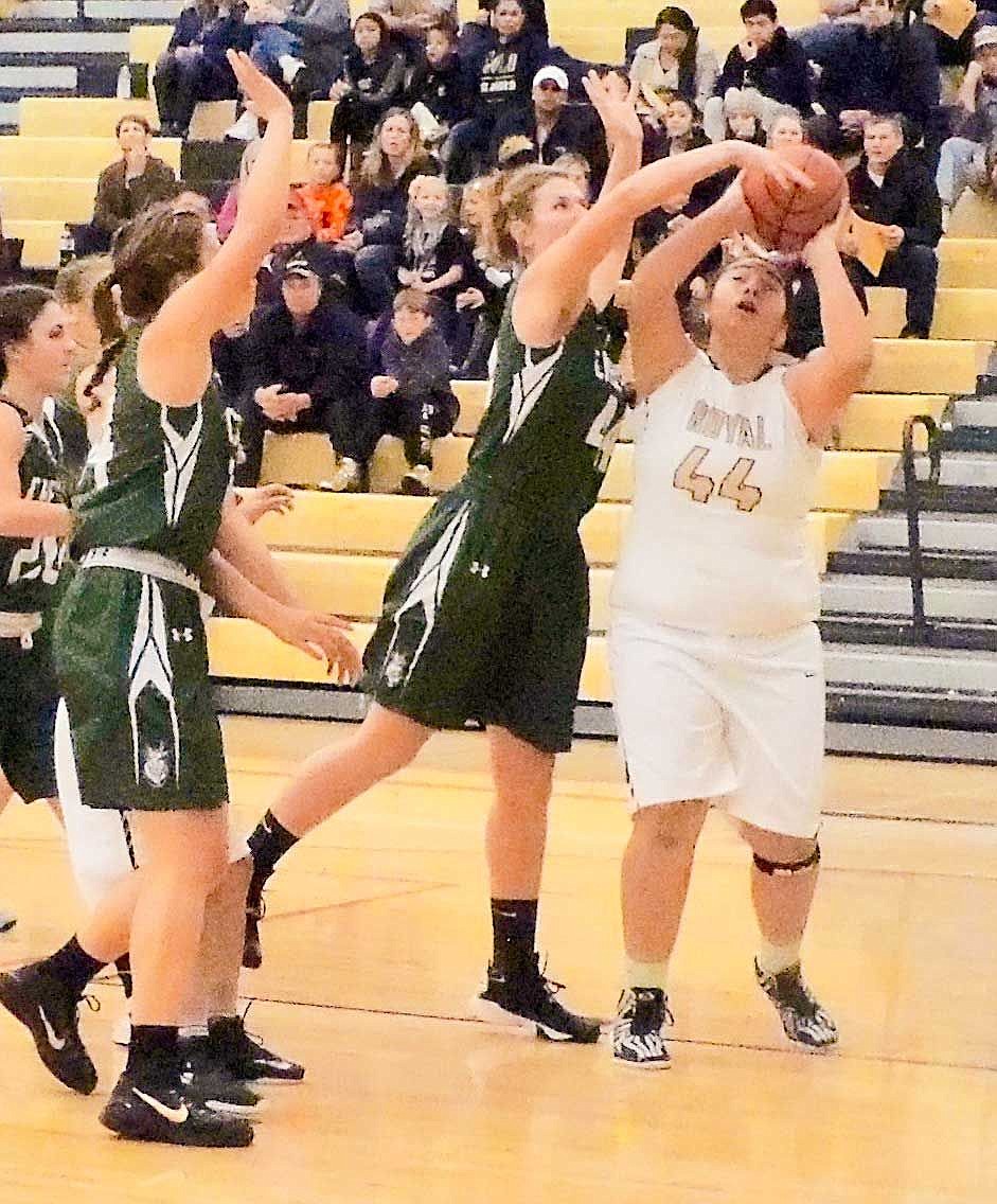 Sophia Rodriguez, at 5-10 the tallest member of the team, tries to go up for a basket, but 6-2 Emma Stockholm checks the attempt.