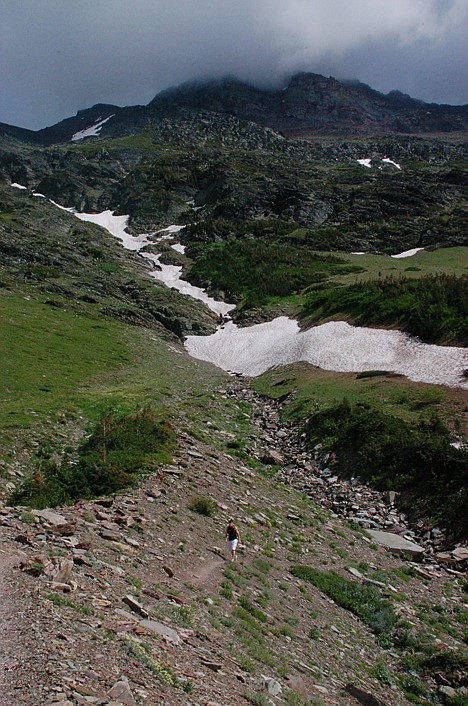 <p>A hiker follows the trail on his return from Cracker Lake at Glacier National Park.</p>