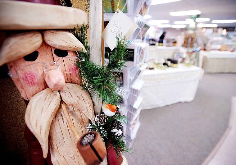 A folk art Santa made from driftwood graces the Main Street entrance of The Christmas Gift Shop in Kalispell.