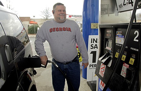 &lt;p&gt;In this Thursday photo, Michael Reed fills his gas tank at a station in Charlotte, N.C. The retail price of gasoline averaged more than $3.50 per gallon for the year, a record. Drivers cut back where they could, driving less and switching to more fuel efficient cars.&lt;/p&gt;