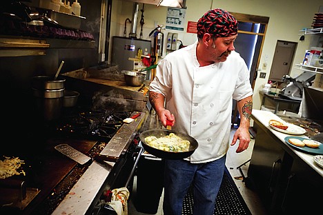 &lt;p&gt;Scott Eberle prepares a customer's order Dec. 14 at KC's Breakfast Club in Post Falls. Last year the owners of the restaurant hosted a free Christmas dinner for thoe in need and ultimately fed 250 people. They are expecting twice that many this year due to the economy.&lt;/p&gt;