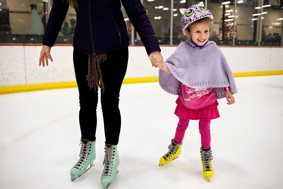 &lt;p&gt;Holding her mother Mariah's hand, Aurora Rodriquez, 5, of Post Falls, smiles as she sports a cat-decorated helmet while ice skating during public skating hours on Saturday at Frontier Ice Arena in Coeur d'Alene.&lt;/p&gt;