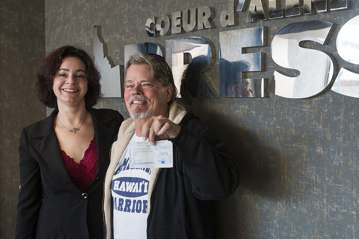 &lt;p&gt;Aafke Murdock with the Coeur d&#146;Alene Press accepts a $1,000 check from Reid Harlocker for Press Christmas for All. The donation, Harlocker said, is in honor of his sister, Anne Hagman, &quot;for all she does for this community.&quot; Press Christmas for All accepts credit card donations as well.&lt;/p&gt;