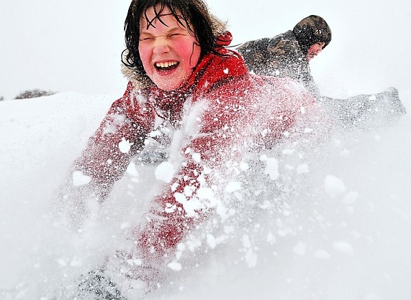 Geneva Sappington, 10, slides past her brother Alan, 9, while sledding at Dry Bridge Park on Tuesday afternoon. The Flathead Valley has received 13.8 inches of snow so far this season.