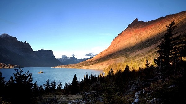 Wild Goose Island and Goat Mountain (right) pick up the early morning light at Saint Mary Lake near the Narrows on Sunday in Glacier National Park.