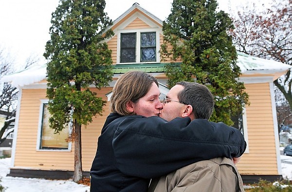 Cinda Stephens shares a kiss with her husband William Berry outside their new home last week. After Cinda injured her back and William returned from working as a private contractor with the military in Iraq, the family was unable to make ends meet. After living in a tent, a camper, and with relatives, the family moved into Samaritan House in Kalispell a few months ago. The family was able to qualify for the house through Veterans Affairs and Housing and Urban Development.