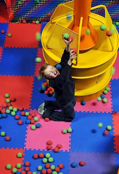 Gaee Giblin has ball fall down on him from second level of the play pen.