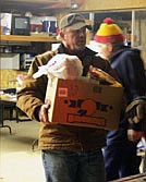 Steve Temple loads a box into the truck on Friday  night before they are delivered.