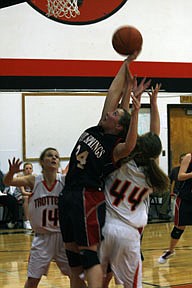 Junior Erin Schmiedbauer one hands a rebound in traffic for the Savage Heat.