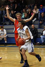 Junior guard Garrett Reinschmidt drives baseline for the Blue Hawks in their 74-71 loss to Eureka.