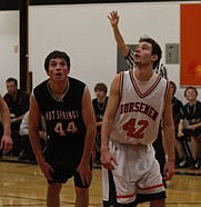 Dave Cross and Tanner Ostrum get into position for the rebound during a freew-throw attempt.