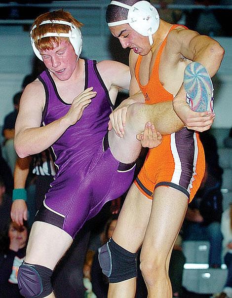 Flathead Senior co-captain Austin Zapata sets-up his opponent Austin Edwards of Missoula Sentinel for one of his seven takedowns during Friday&#146;s dual in Kalispell. Zapata won the 135-pound match 15-4 and Flathead won the team battle, 69-7. Chris Jordan/Daily Inter Lake