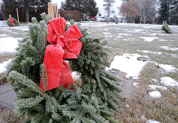 <p>A newly placed wreath sits atop the grave of a veteran at
Glacier Memorial Gardens cemetery on Friday morning north of
Kalispell. Approximately $2,500 worth of wreaths were stolen from
the graves in mid-December.</p>