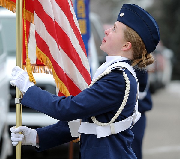 <p>Cadet 2nd Lt. Lizzy Rodwick positions the American flag at the
start of the wreath  ceremony on Friday at Glacier Memorial Gardens
cemetery north of Kalispell.</p>
